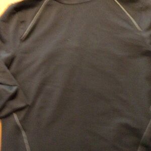 Activewear top by Under Armor.  Black with silver/gray trim. EUC.